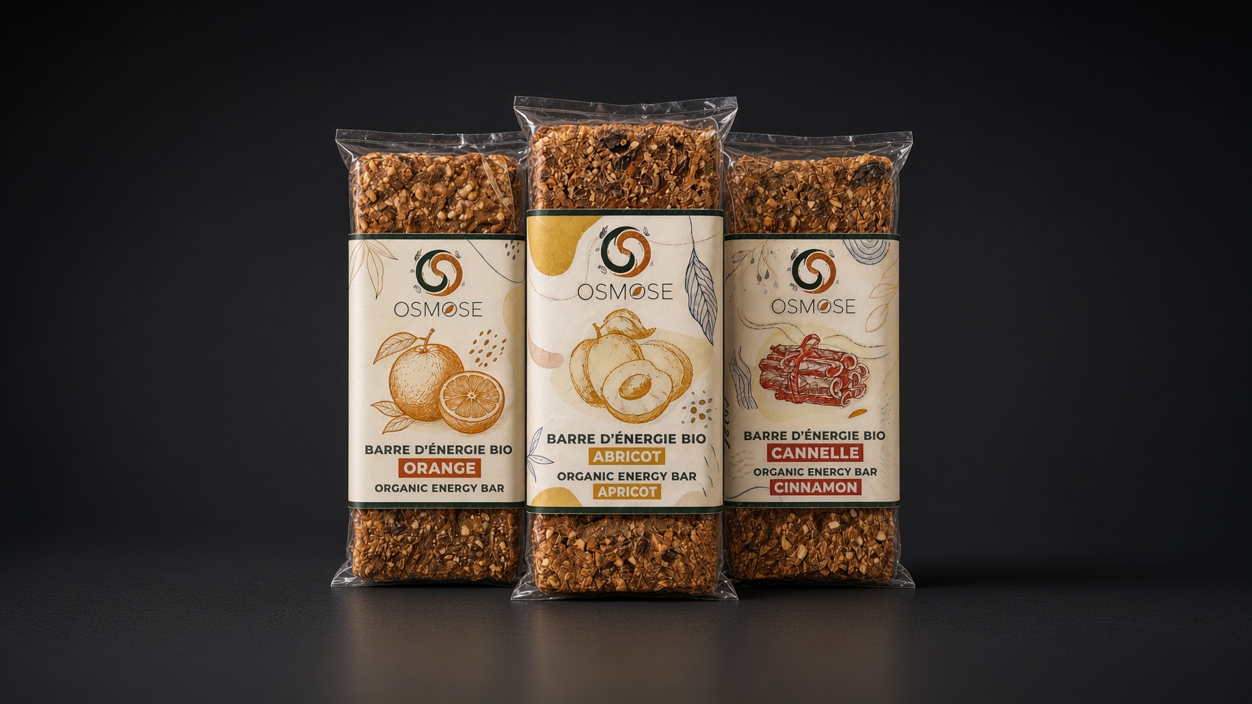 Trois barres Osmose Orange, Abricot et Cannelle dans leur emballage en cellulose